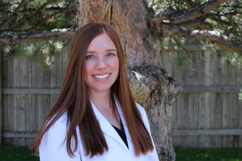Dr. Brittany Ballard smiling in a white coat