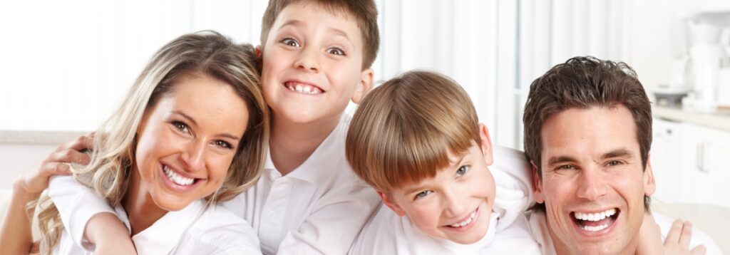 Smiling family of four posing together