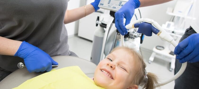 Smiling young girl in the dental chair during a checkup