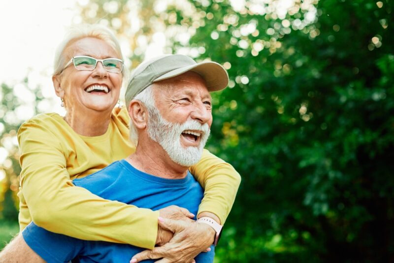 Laughing older couple embracing outdoors