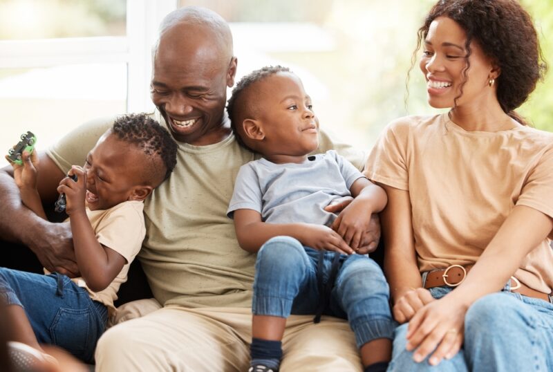 Smiling parents with two young children at home