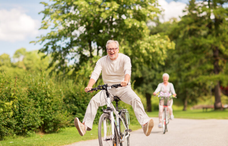 Older couple riding bicycles in a park